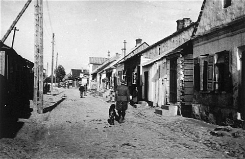 German soldier with his dog patrols the ghetto at Konska-Wola